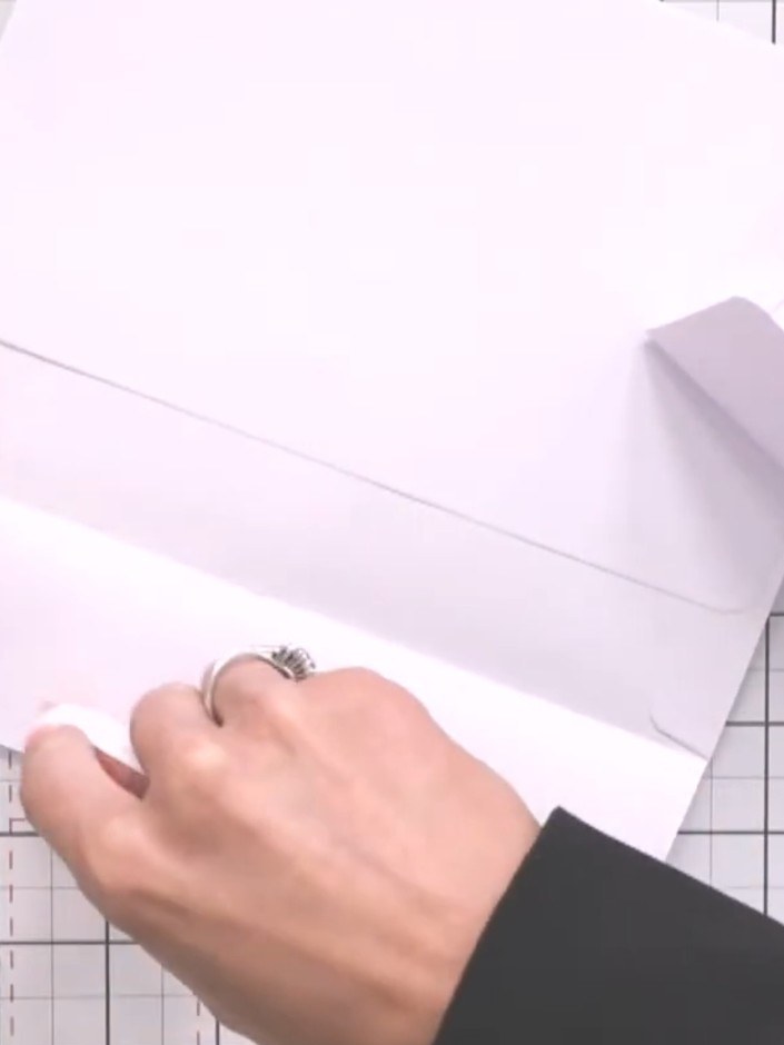 Step 1: Take two envelopes and seal the short flap of the first envelope closed using tape.