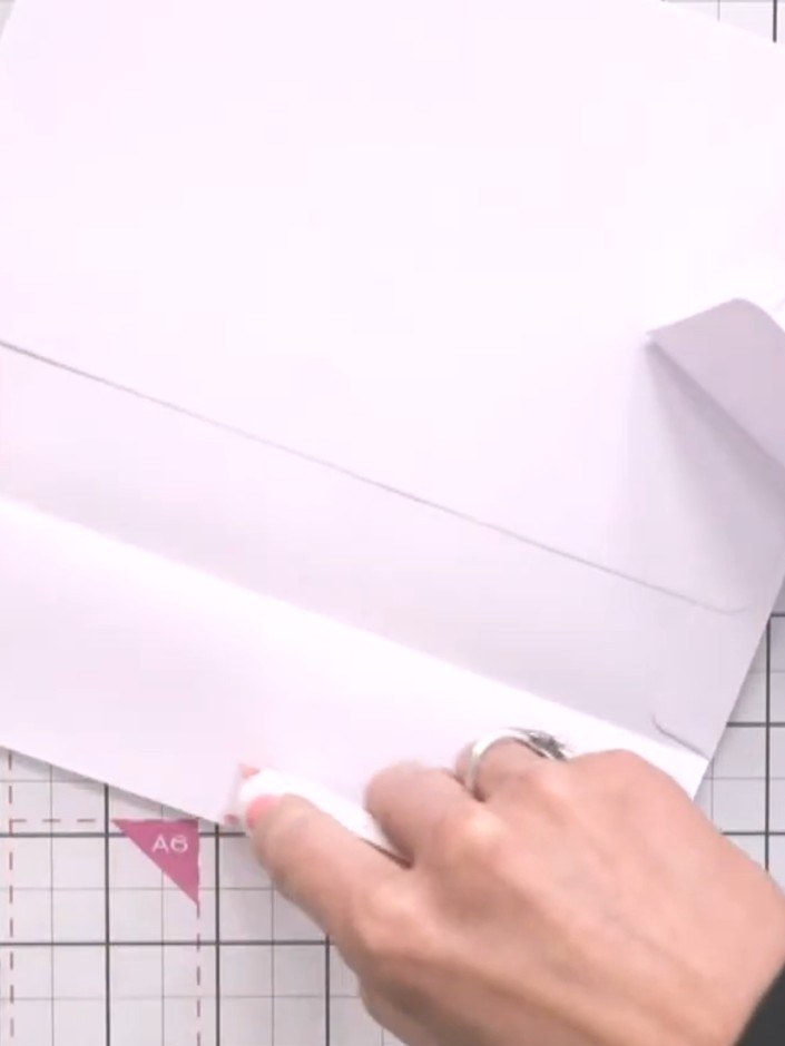 Step 2: Apply adhesive tape to the flap of the second envelope and adhere it to the edge of the first envelope to crea