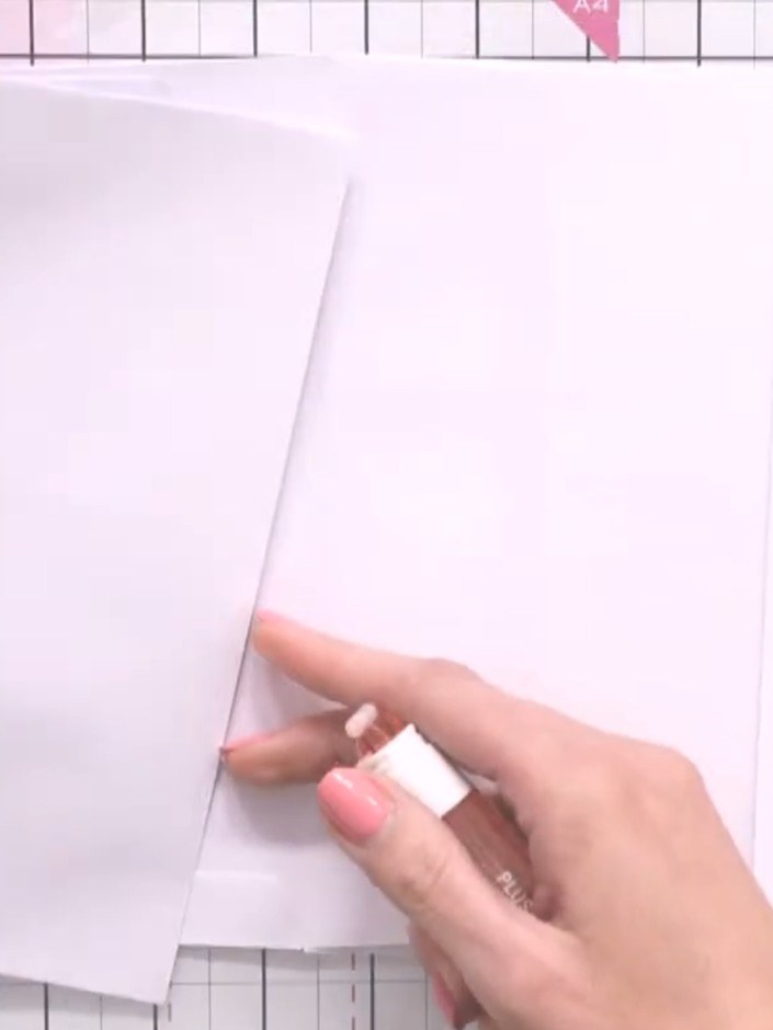 Step 8: Cut corner triangles from contrasting paper and glue them to the inside pages to create additional pockets. Po
