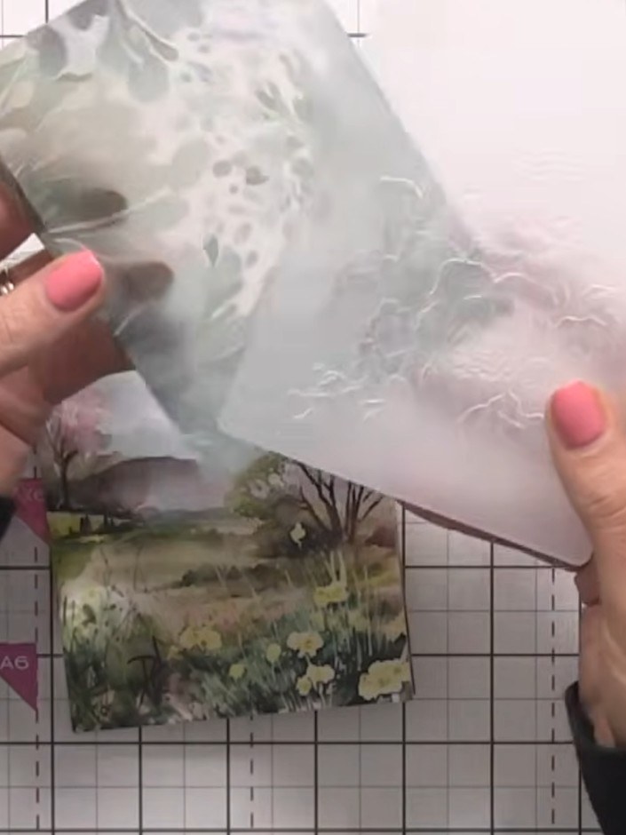 Step 7: Run the corner of the vellum through an embossing folder to add a delicate embossed detail, such as a rose, to