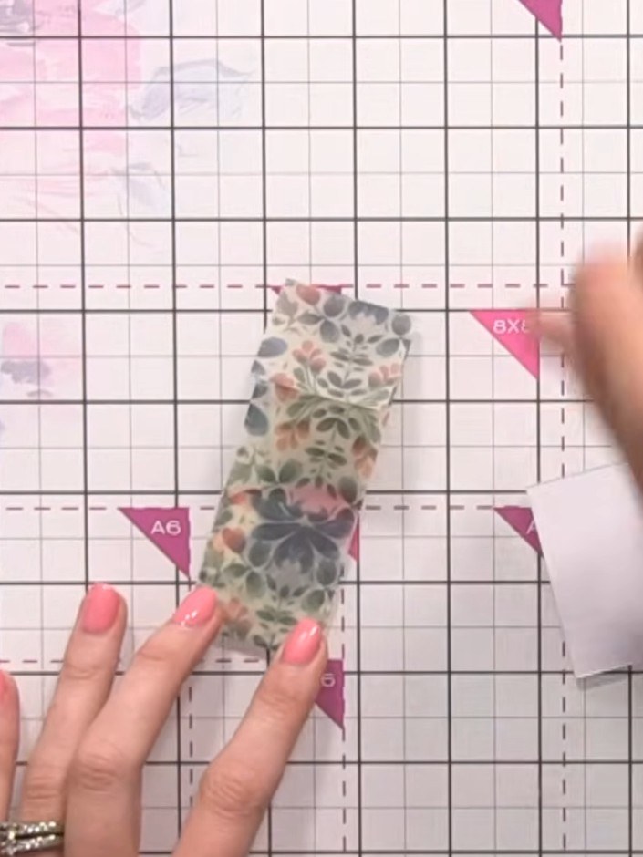 Step 7: Wrap the vellum belly band around your finished card, holding it in place with your finger whilst positioning 