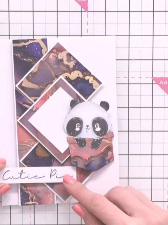 Step 12: Position the 'Cutie Pie' sentiment stamp on white cardstock and adhere it to the lower portion of the card des