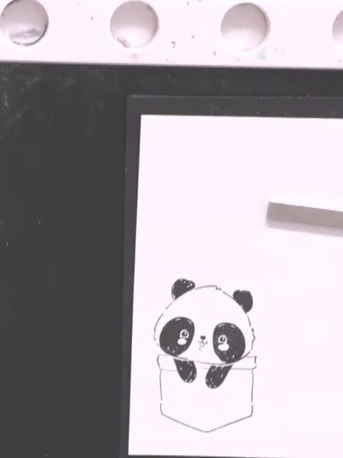 Step 2: Stamp the panda pocket image from the Pocket Pals stamp set onto white cardstock using black ink. The panda sh