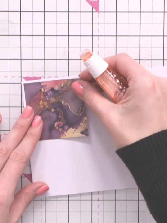 Step 6: Apply glue to the back of the patterned square and adhere it onto white cardstock to create a matted layer.