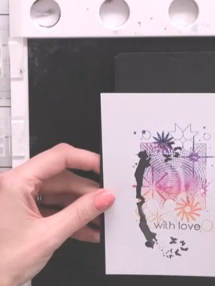 Step 12: Attach the completed layered panel to a white card blank using adhesive. Add extra sparkle or embellishments i