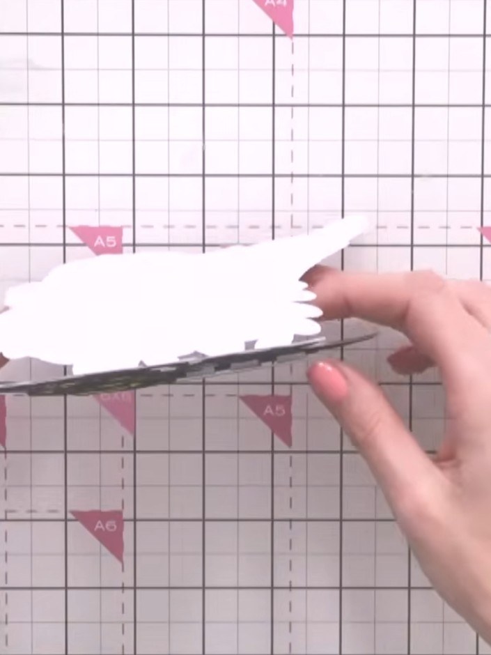Step 5: Cut the die shape from black cardstock using your die cutting machine. The die will cut out the decorative flo