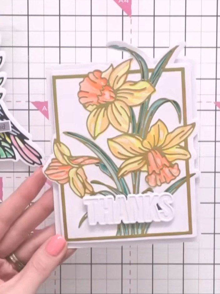 Step 6: Layer your die-cut floral shape on top of the stencilled background card to create dimension. Position the die
