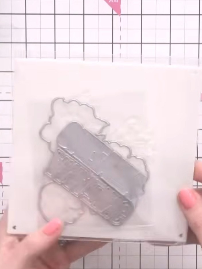 Step 3: Position the stencil on your white card panel, aligning it with the edge of the paper or using the heart regis