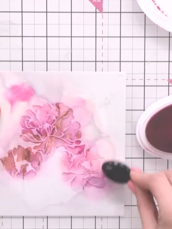 Step 6: Ink through stencil number two using the same pink ink or a slightly darker shade. Apply the ink with a blendi