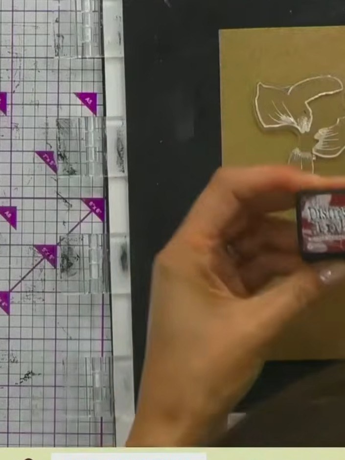 Step 3: Ink up the embossed dove stamp by tapping multiple Distress Ink colours onto it. Use white, orange and pink in