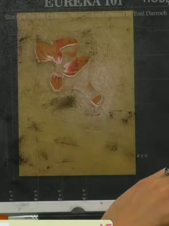 Step 5: Stamp the flower and leaf images onto your gold card using the orange ink, pressing down firmly to transfer th