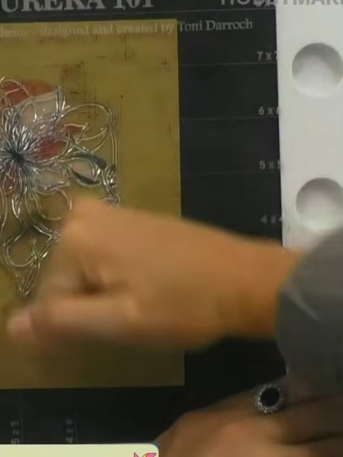 Step 9: Stamp the detailed outline portion of the flower stamp onto the card over the watercoloured image to complete 