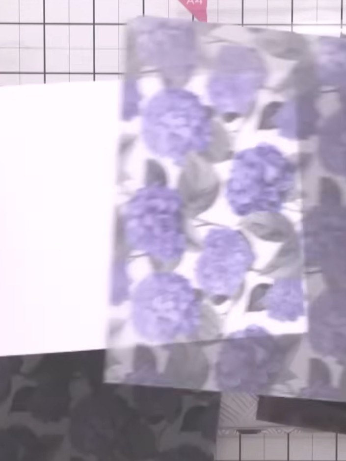 Step 7: Weave the vellum sheet with purple hydrangea flowers through the openings of the trellis, positioning them to 
