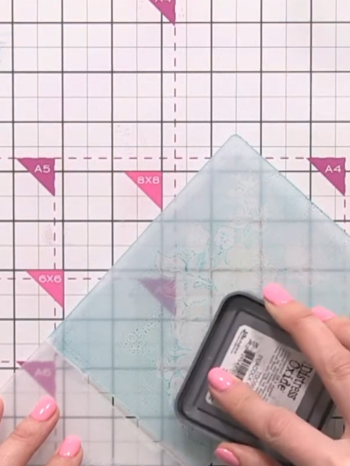 Step 8: Lightly spray the inked embossing folder with water to help transfer the ink to the paper. The layers can be u