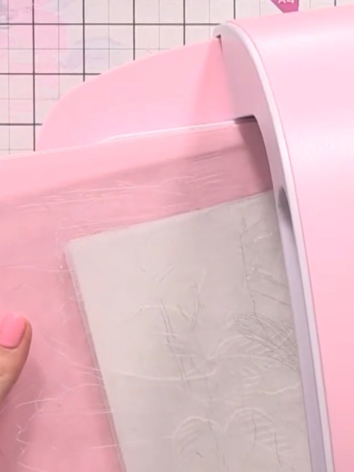 Step 2: Using a damp brush with clean water, carefully wet the first petal of the embossed white rose design. Be preci