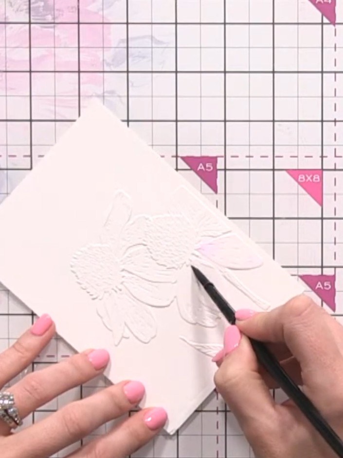 Step 5: Continue applying water followed by diluted purple watercolour to the remaining rose petals on the embossed ca