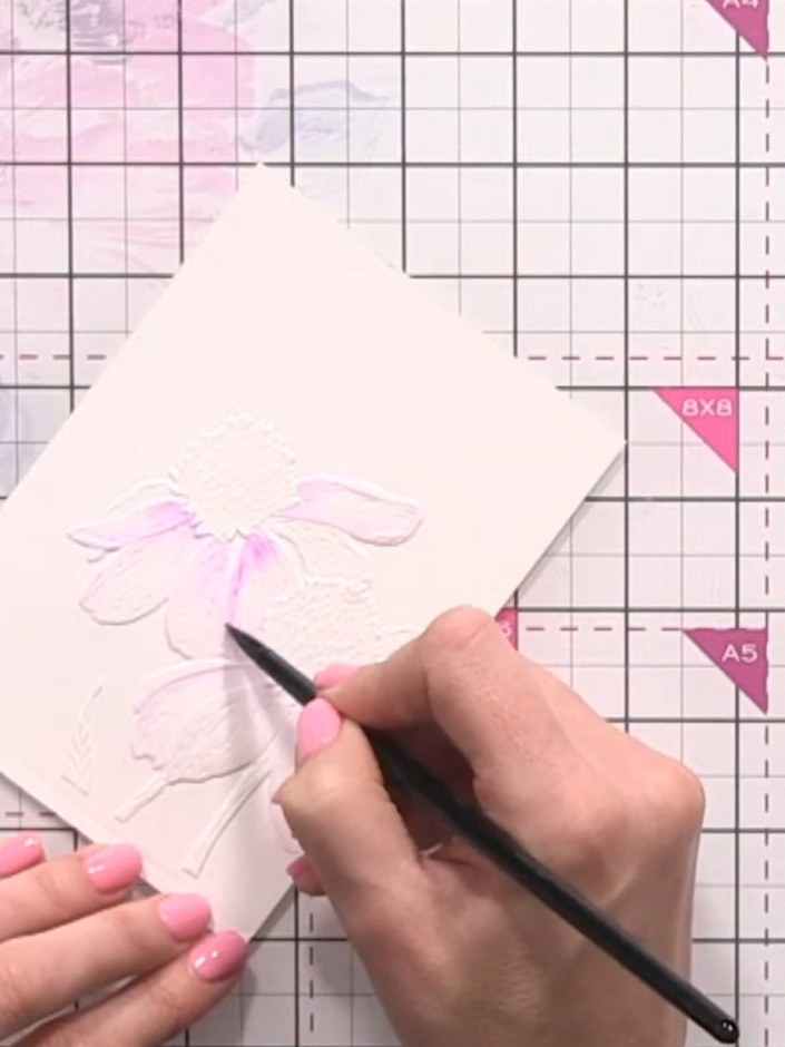 Step 7: Wet the centre area of the flower with clean water using a paintbrush. Drop in diluted yellow ink to the dampe