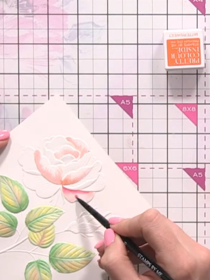 Step 8: Using a fine brush or pen, drop diluted pink ink into the centre and base of the orange rose petals to create 