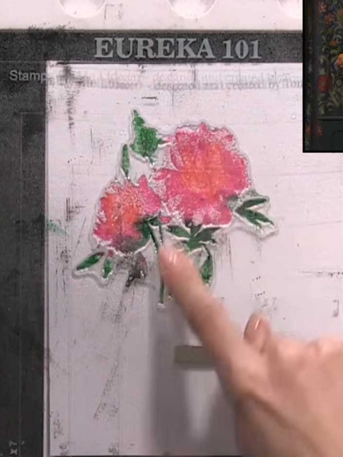 Step 4: Apply green ink to the leaves of the stamped floral design. Press and blend the ink onto all the leaf areas to