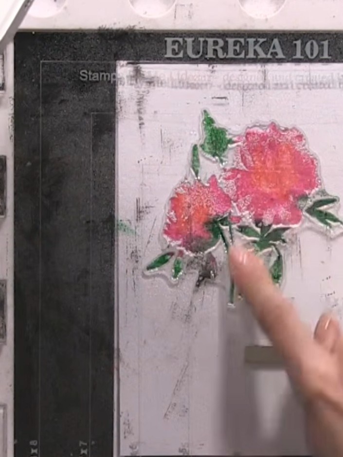 Step 6: Press the lamination stamp firmly onto the card to transfer the watercoloured floral image. Apply even pressur