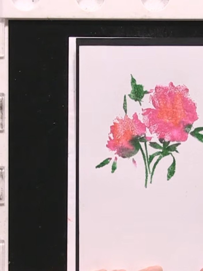 Step 8: Line up the detailed stamp overlay on top of the coloured flower design, ensuring it aligns precisely with the