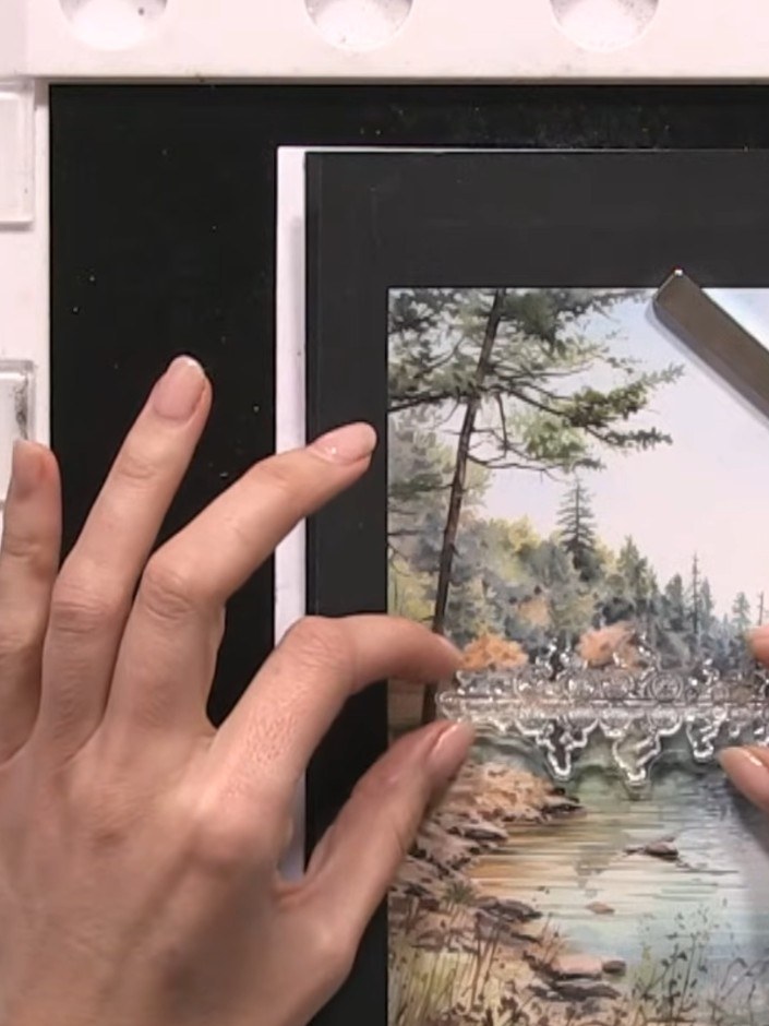 Step 4: Re-ink the top portion of the landscape stamp with darker black ink, focusing on the sky and tree areas to cre