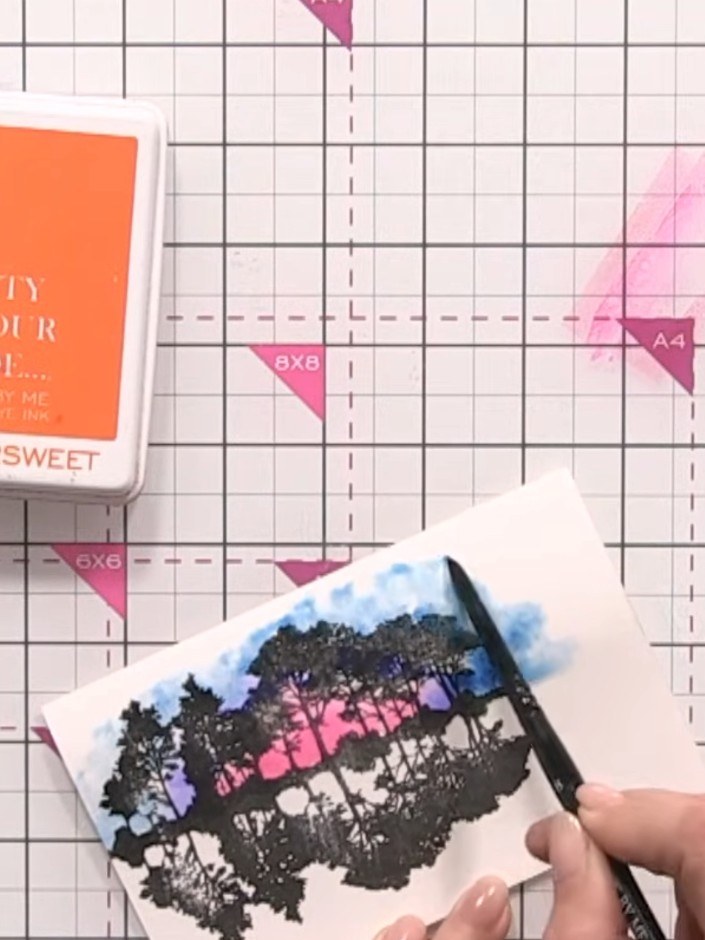 Step 8: Add a touch of orange ink from the Bittersweet stamp pad around the sunset area to create an African sunset ef