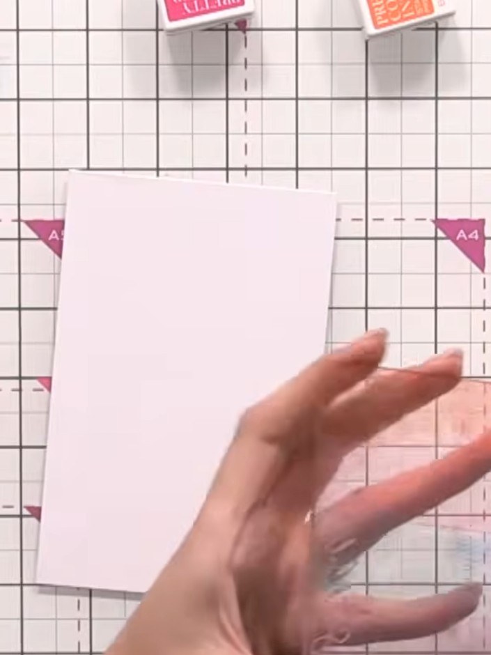 Step 11: Spray the inked acrylic block generously with water until saturated. Press the block upside down onto a pale p