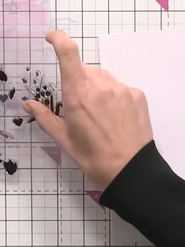 Step 2: Ink up stamp number one with orange and pink ink, aligning the heart positioning marker on the stamp with your
