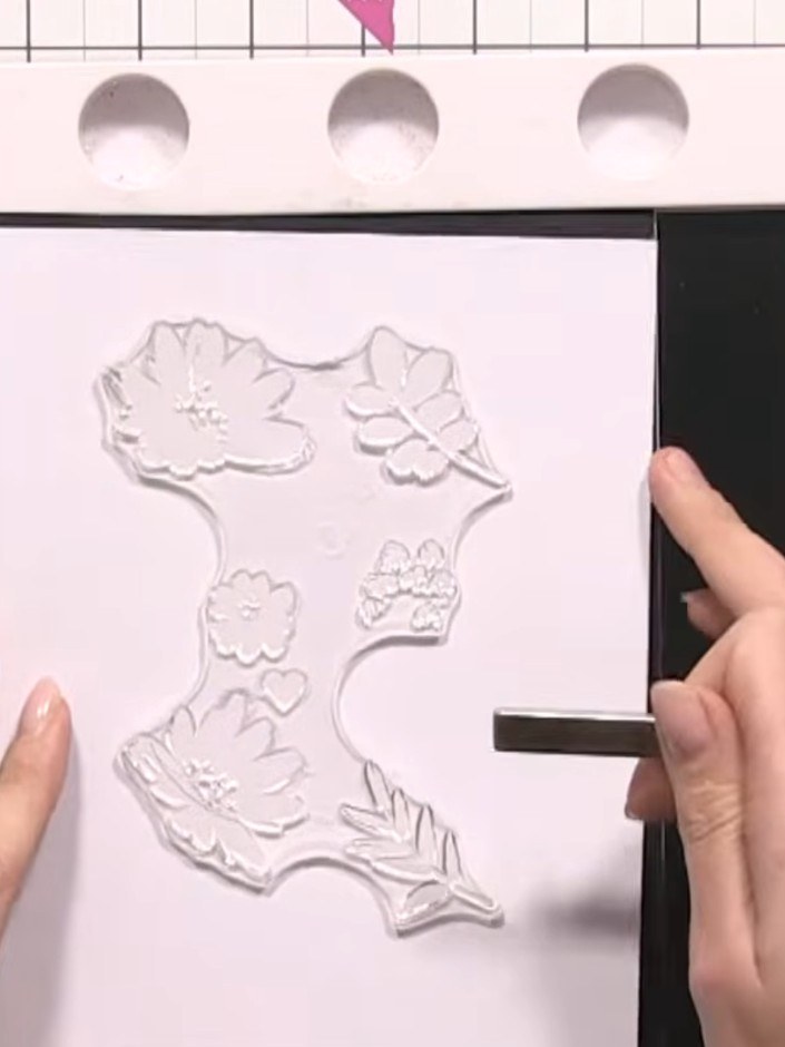 Step 3: Spray the inked stamp three times with water to create a watercolour effect, then press firmly onto the white 