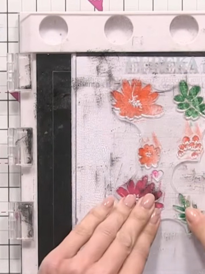 Step 5: Spray the stamped flowers with water using a spray bottle. Press stamp number two onto the wet card to add the