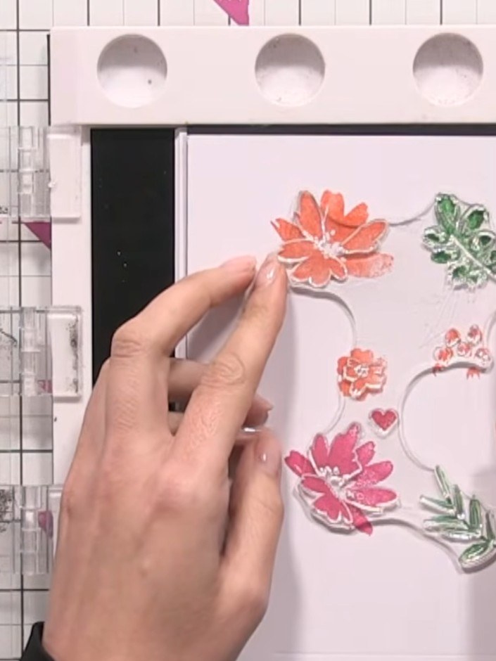 Step 7: Use stamp number four to add fine detail to the flower centres and leaves. Apply yellow ink to stamp the centr