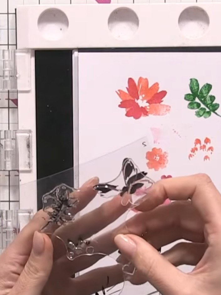 Step 8: Carefully tear away the excess card around the stamped floral design to create a rough, organic edge. Remove a