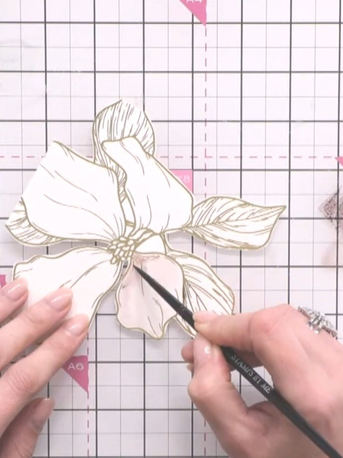 Step 4: Use a clean, damp brush to drag the colour outward from the centre of each petal, creating a soft gradient eff