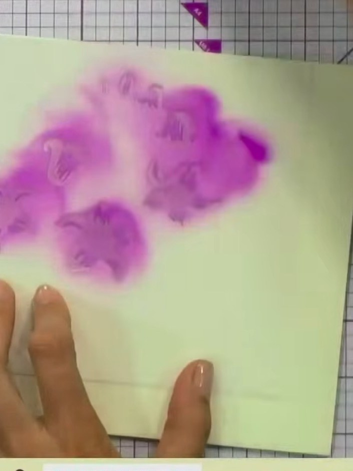 Step 4: Position stencil number two over the same area and apply more purple ink using the blending tool. Press slight