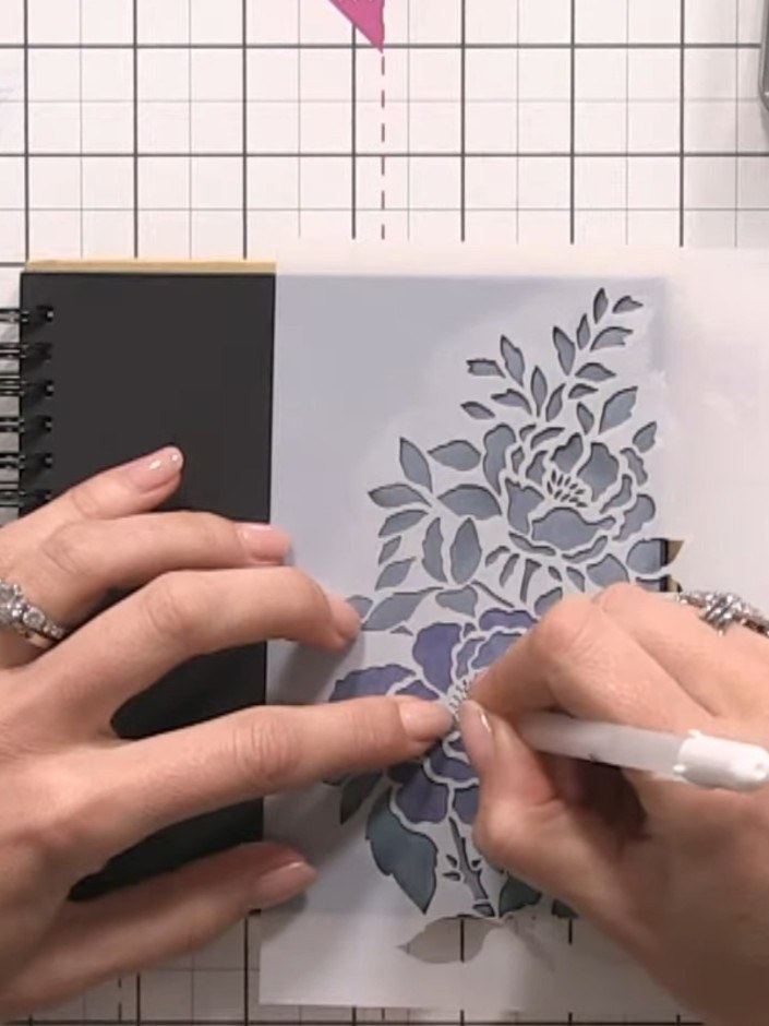 Step 7: Once the ink is completely dry, use a white gel pen to outline the stencilled floral design. Work carefully ar