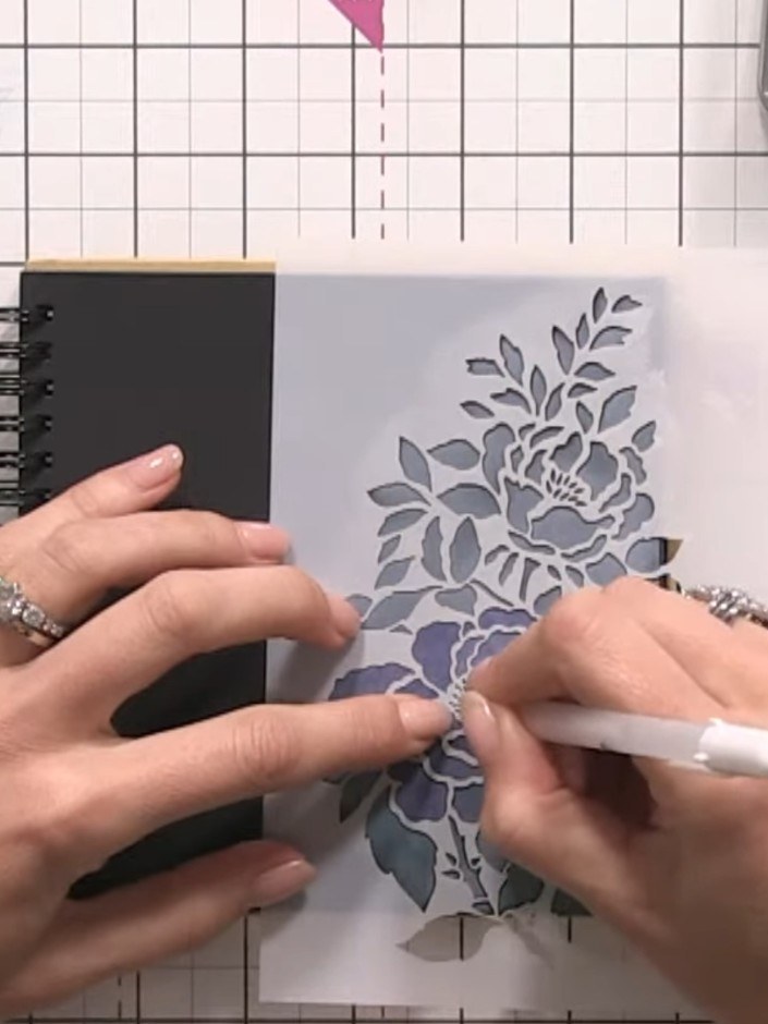 Step 5: Using a white gel pen, carefully outline the centre details of the fern design by following the stencil holes 