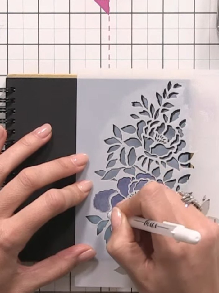 Step 6: Replace the stencil over your design and use a white gel pen to carefully outline the outer edges of the fern 