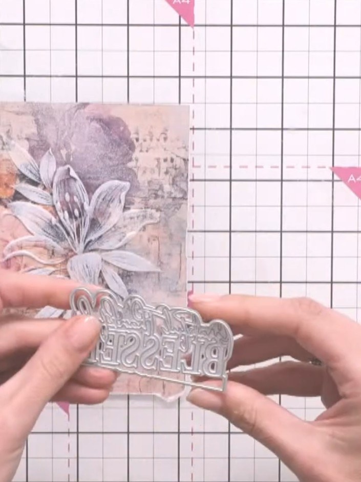 Step 7: Adhere the sentiment die-cut to the centre of the wreath using glue, positioning it over the floral design.