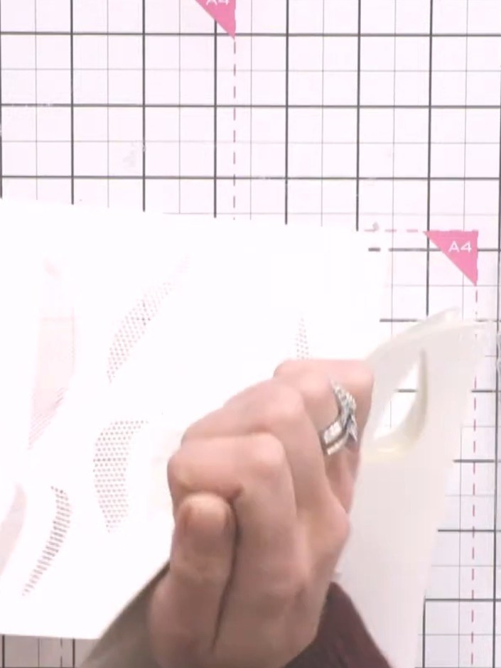Step 4: Select stencil number two from the Dotted Tulips set. Line up the stencil with the edge of your card, ensuring