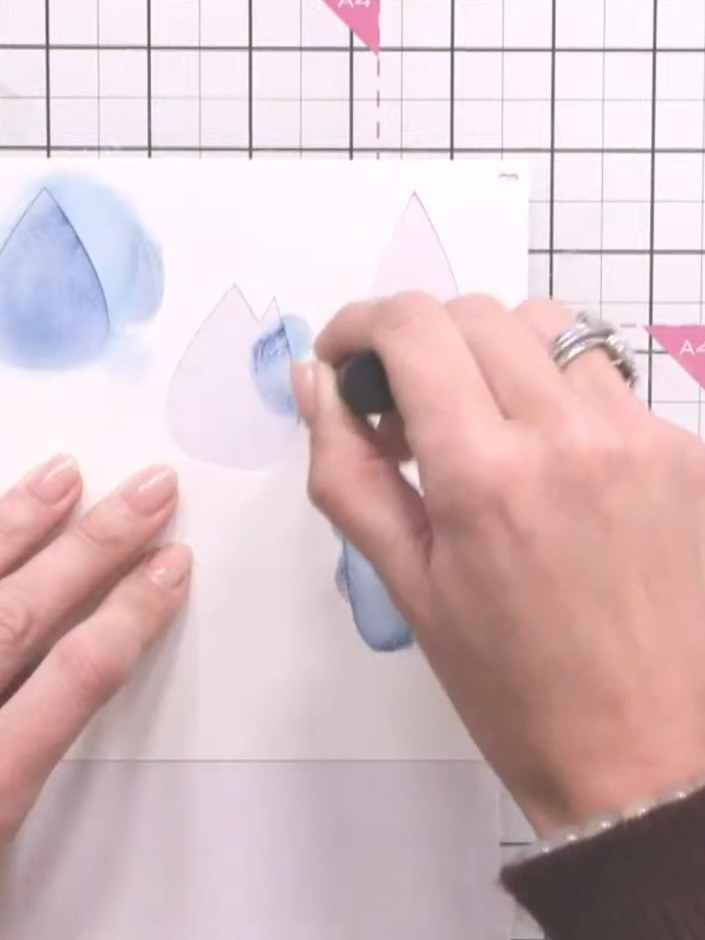 Step 7: Apply embossing ink through one of the tulip stencils onto your card. Sprinkle embossing powder over the inked