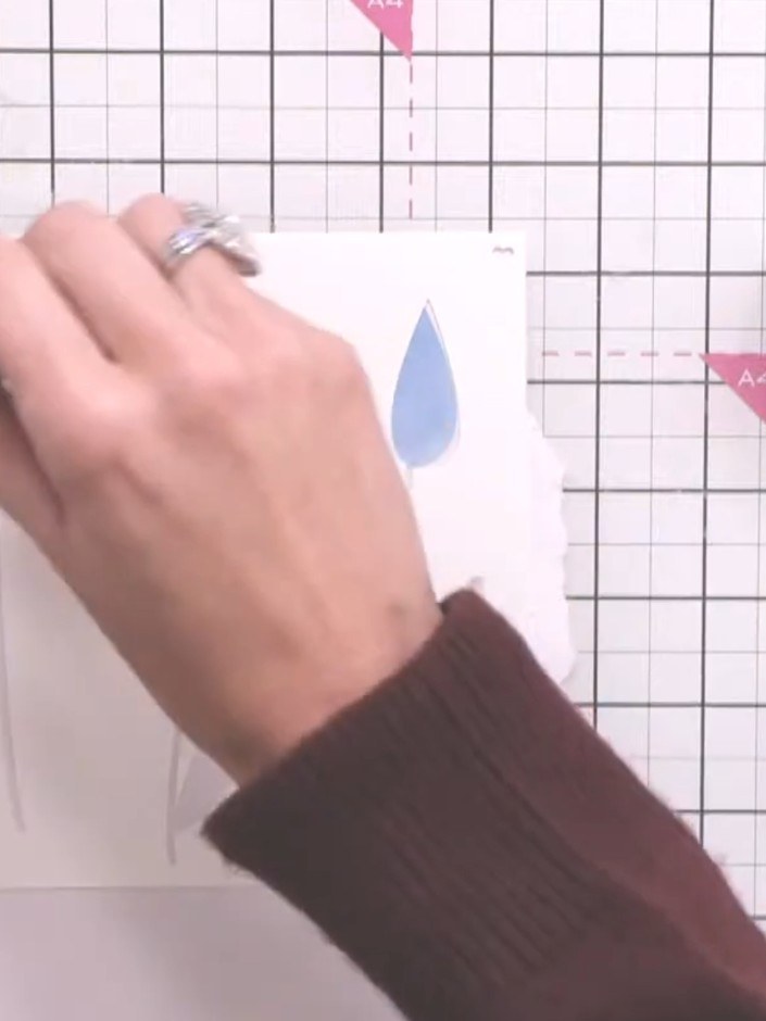 Step 9: Mount the completed tulip design onto your card base using adhesive. Smooth down carefully to ensure it is sec