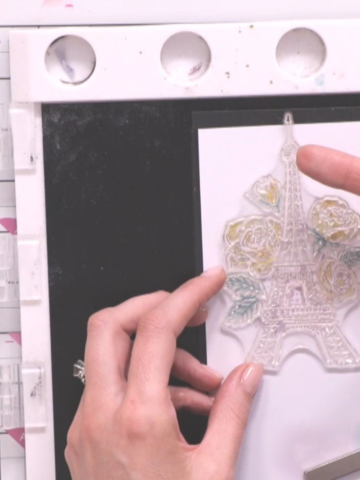 Step 10: Place the stamped Paris tower piece into your die-cutting machine along with an embossing folder to add textur
