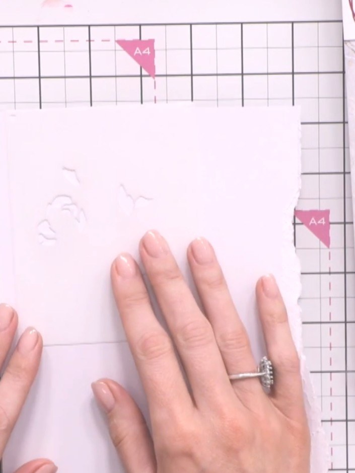 Step 2: Position stencil number one on your white card base, aligning it with the edge using the heart guides in the c