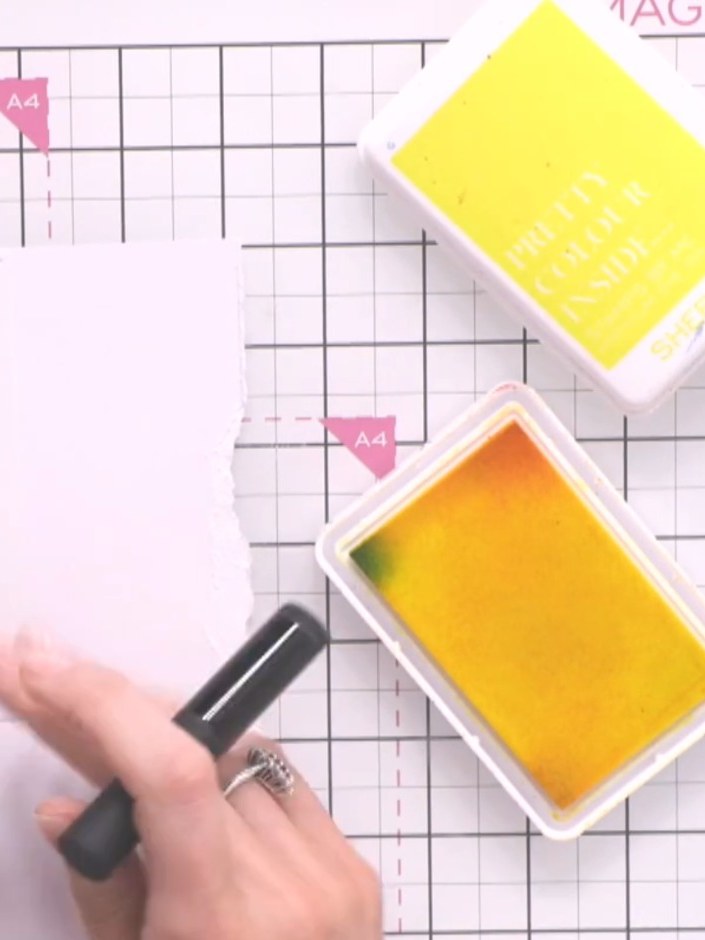 Step 3: Use the yellow ink pad with the stencil to apply light colour to your card base. Gently dab the ink through th