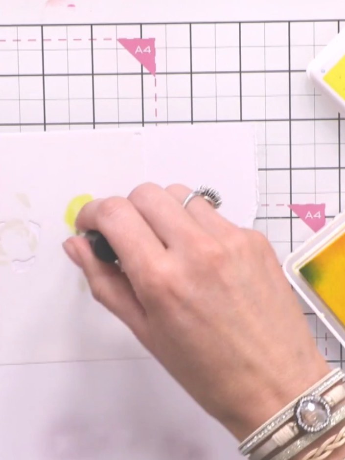 Step 5: Position stencil three over your card. Using a blending tool, apply yellow ink through the stencil, then add o