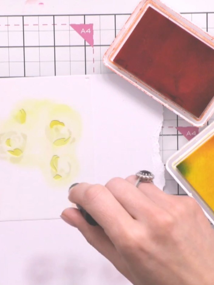 Step 6: Position stencil four over your card and apply teal or green ink through the stencil to create foliage details