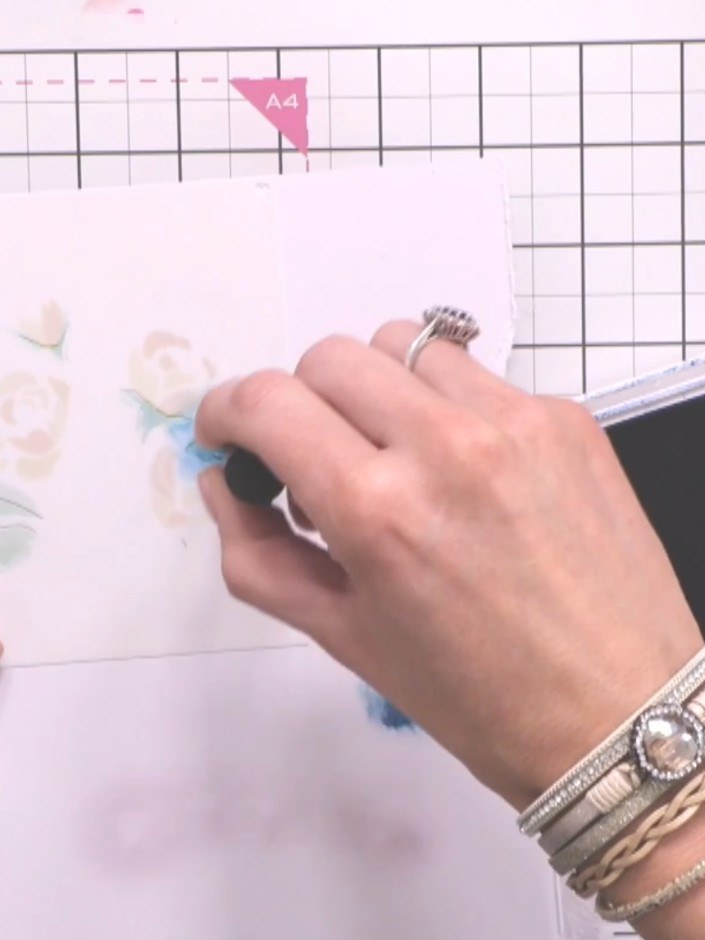 Step 8: Position stencil six over your card and apply purple ink very lightly using a blending tool to create decorati