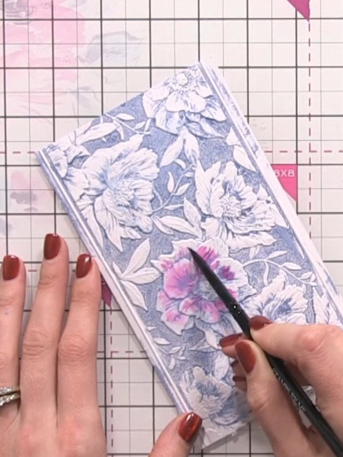 Step 6: Wet each flower individually with clean water using a brush. Drop pink, yellow and green ink onto the wet area