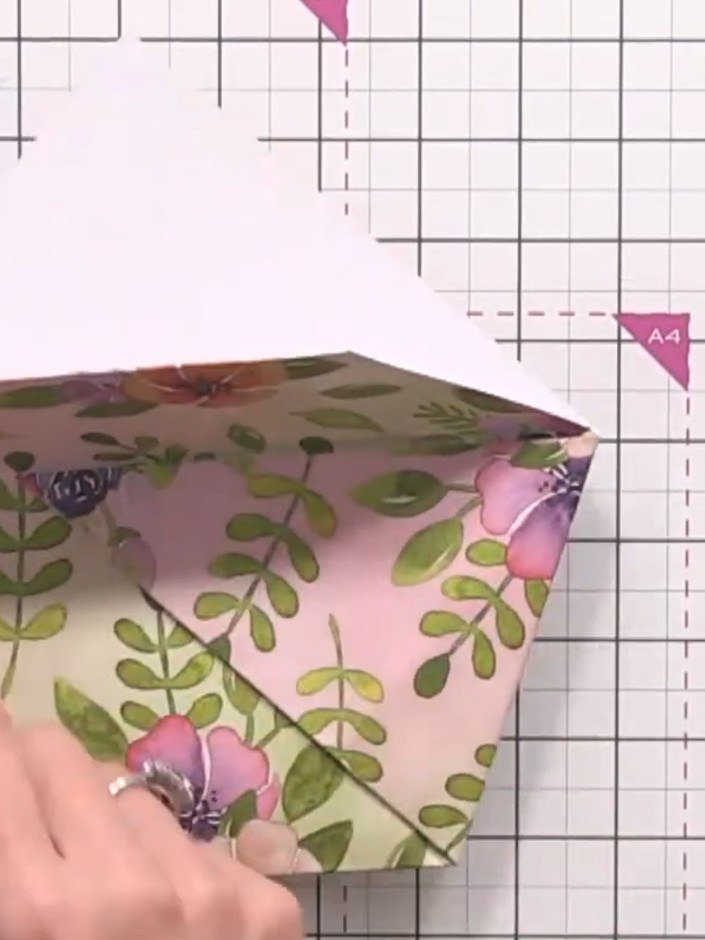 Step 9: Fold the front flap upwards to display the floral pattern on the exterior of your gift wallet. Press firmly al